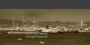 Sepia image of old ships in San Francisco Harbor.