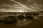 A dramatic sepia sunrise with the Moeraki boulders foreground splashed with time lapsed waves.